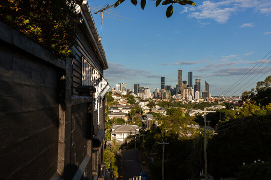 side of a shady timber house with Brisbane city in the background