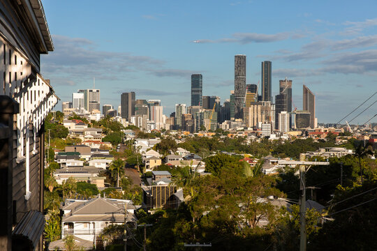 looking towards Brisbane City from Paddington with an old timber house in frame