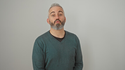Portrait of a handsome young caucasian man with a beard, making a kissing gesture against a white...