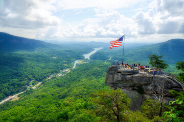 A beautiful scenic view of Chimney Rock and Lake Lure down below in the Hickory Nut Gorge in North Carolina in HDR.