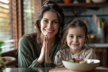 Smiling Mother and Daughter at Kitchen Table with Bowl of Salad
