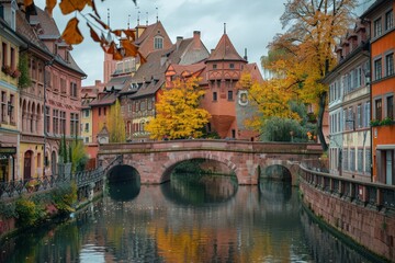 Fototapeta premium Historic European Town with Brick Buildings and a Stone Bridge over a River
