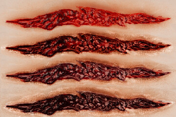 Closeup on four bloody scars in different shades of color. Ideal for photo editing.