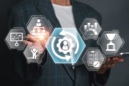 A business professional demonstrates the concept of change management using digital icons and graphs, highlighting organizational transformation and strategy.