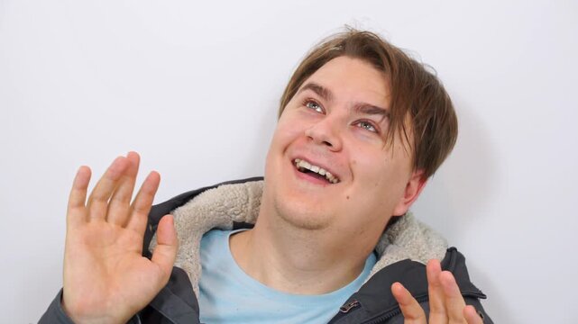 Portrait of crazy strange man with hallucinations, waving arms, turning his head Alcohol intoxication, psychotropic substances, delirium of madman from overheating Face of drug addict under mushrooms