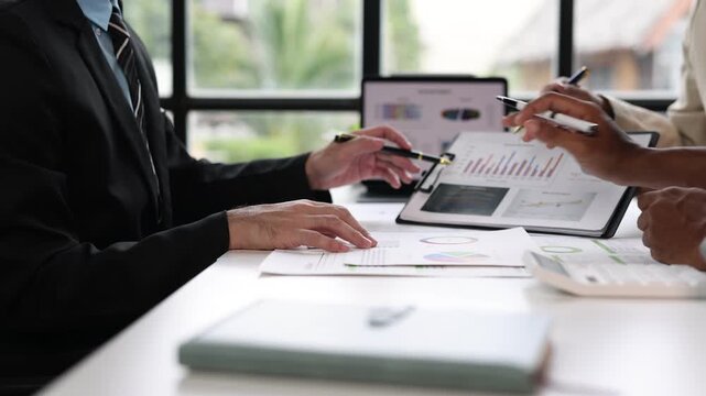 Businessman meeting with colleagues, discussing the sales situation and making a marketing plan. Brainstorming, discussing financial analysis and planning business strategies.