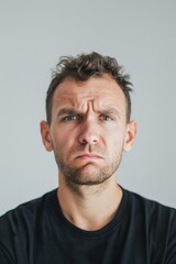 Obraz premium Concerned Man in Black T-Shirt