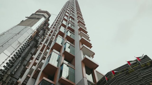 Underview from the street of the SLS Building Residences and Hotel in Business Bay, Dubai, highlighting its luxurious balconies and modern architecture against the cityscape.