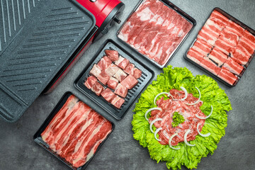 A variety of meats and vegetables are displayed on a counter