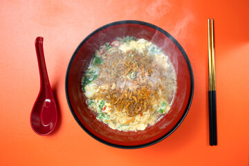 A bowl of instant noodles with a spoon next to it