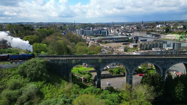 Steam Train, Drogheda, County Louth, Ireland, April 2023. Drone tracks left to right following C&uacute; Chulainn Express pulled by No.85 Merlin Steam Locomotive as it approaches the Boyne Viaduct.