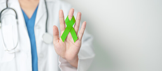 Doctor with green Ribbon for world Lymphoma Awareness September month, world Mental Health Day,...