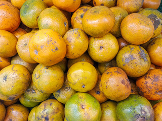 piles of orange fruit ready to eat or sell at the market