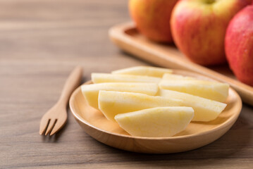 Sliced red apple fruit (Envy apple) on wooden plate with fork ready to eating, Healthy fruit