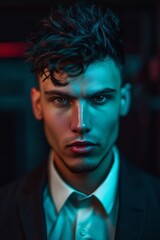 A man with blue eyes in a dark room