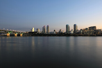 Cheongdam-dong, Gangnam-gu, Seoul, South Korea - August 23, 2022: Sunset and night view of Cheongdam Bridge on Han River with Olympic Boulevard and apartments
