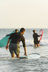 Group of friends starting the surfing session during their vacation