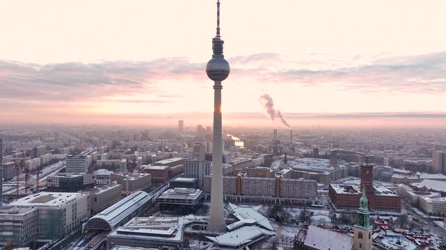 City of Berlin, Germany from above. Aerial winter cityscape view at sunrise or sunset, showing architectural landmarks Oberbaum Bridge, TV Tower and Berlin Cathedral in winter. 