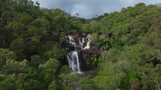 Cedar Creek Falls waterfall Proserpine rainy season QLD Australia aerial drone view Whitsundays islands Port of Airlie Beach sunny bluesky morning daytime Conway Forest Reserve Palm Grove circle right