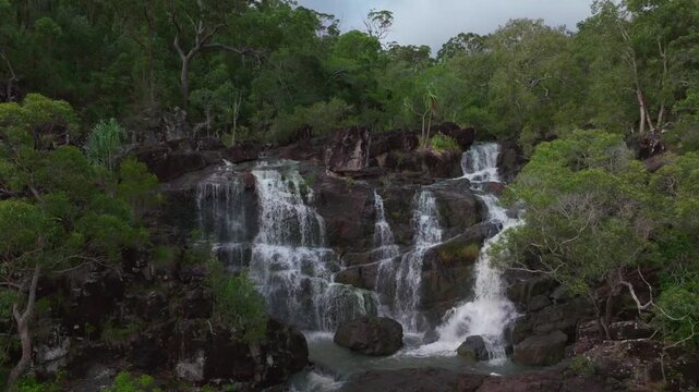 Upper Cedar Creek Falls waterfall Proserpine rainy season QLD Australia aerial drone view Whitsundays islands Port of Airlie Beach clouds shade morning daytime Conway Forest Reserve Palm Grove static