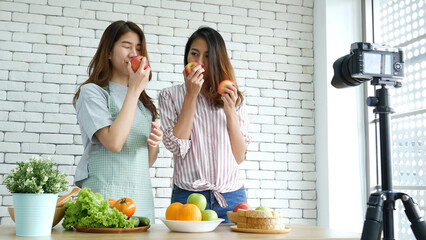 Asian influencer vlogger live review healthy eating lifestyle. Two Young woman friends blogger vlog...