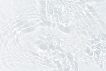 White water with ripples on the surface. Defocus blurred transparent white colored clear calm water surface texture with splashes and bubbles. Water waves with shining pattern texture background.