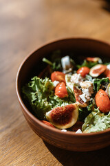 On the table, there is a cream soup with mushrooms, next to it beef with vegetables, and a salad with chicken