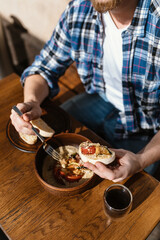 handsome man is eating delicious cream soup in a beautiful, cozy bar