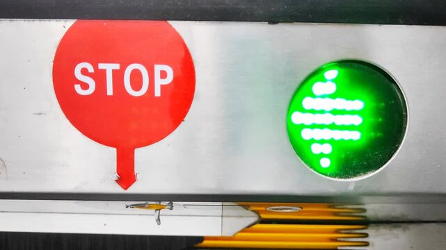 Moving electric arrow light leading to the stop sign in eskalator. 