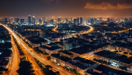 Fototapeta premium Night cityscape with illuminated highways and buildings.