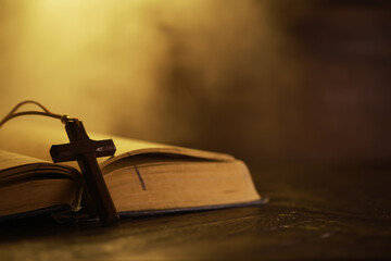 Wooden Cross on Bible in Warm Light Symbolizing Faith, Spirituality, and Devotion