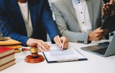 Business and lawyers discussing contract papers with brass scale on desk in office. Law, legal services, advice