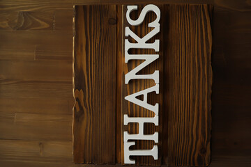 Wooden Background with Thanks Sign in White Letters for Gratitude and Appreciation Themes