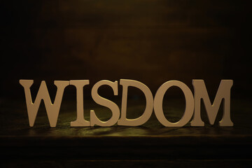 Wisdom Sign in Dim Lighting with Wooden Background - Calm, Knowledge, Serenity