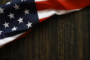 American Flag Draped on Dark Wooden Background - Patriotic Symbol of USA