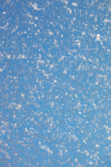 Close-up of Frosty Snowflakes on Blue Sky Background