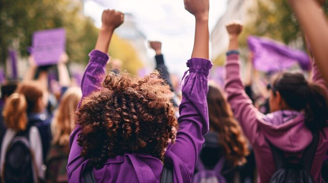 Defending women's rights and promoting female empowerment at a strong demonstration on International Women's Day, adorned in shades of purple.