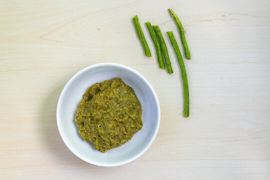 Delicious borboti bhorta in a white bowl on wooden background. It is very popular vegetable in Bangladesh. It is also known as yardlong bean, asparagus bean, long bean, and snake bean.