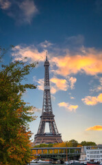 Paris with Eiffel Tower iconic Paris landmark across the River Seine with  tourist boat in  Autumn tree fall scene at Paris ,France