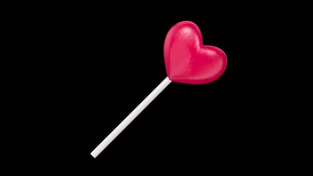 Red heart-shaped lollipop on a black background