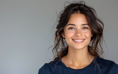 Fototapeta premium A joyful fictional woman with wavy hair beams with happiness, showcasing her glowing smile in a relaxed, light-filled atmosphere