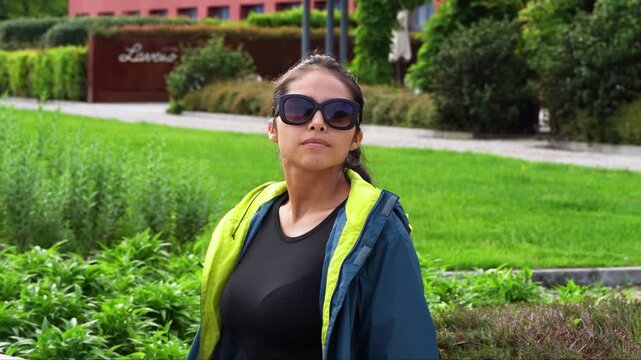 Female Traveler In Sunglasses At Park In Laveno-Mombello, Lombardy, Italy. sliding shot
