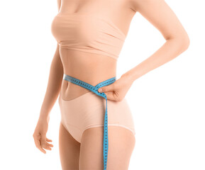 Young woman measuring her waist on white background. Weight loss concept