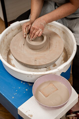 Wheel throwing. Learning how to model clay into different shapes with pottery wheel. Creating a ceramic bowl by yourself in a pottery class.