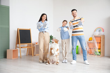 Happy family with gloves and dog during repair in children's room
