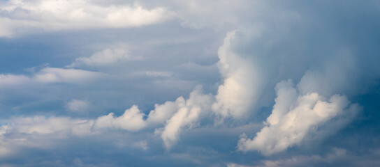 Dramatic blue sky with clouds of different shapes