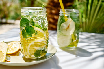 Detox drink. Infused water with lemon mint and rosemary. Refreshing summer homemade cocktail. Fresh healthy cold beverage.