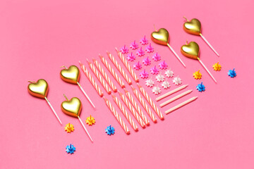 Different Birthday candles on pink background