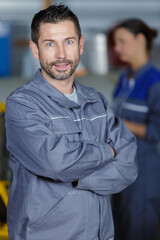 Fototapeta premium a happy mature mechanic with armscrossed