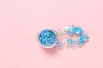Jar of blue glitter with stroke on pink background